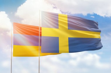 Sunny blue sky and flags of sweden and armenia
