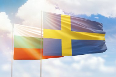 Sunny blue sky and flags of sweden and bulgaria