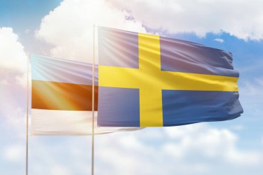 Sunny blue sky and flags of sweden and estonia