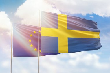 Sunny blue sky and flags of sweden and european union