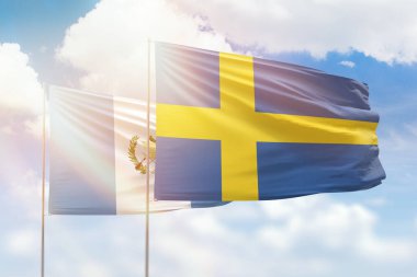 Sunny blue sky and flags of sweden and guatemala