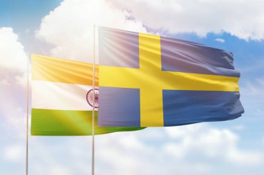Sunny blue sky and flags of sweden and india