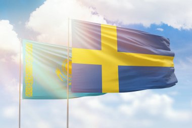 Sunny blue sky and flags of sweden and kazakhstan