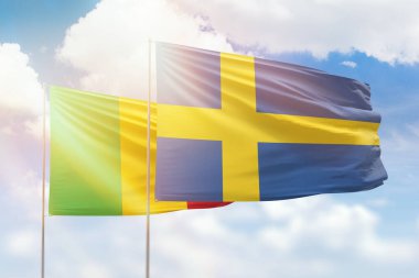 Sunny blue sky and flags of sweden and mali