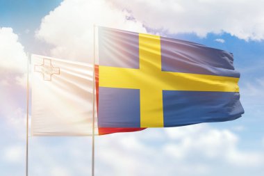 Sunny blue sky and flags of sweden and malta