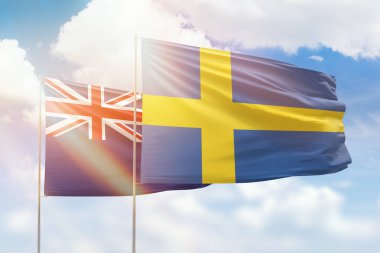 Sunny blue sky and flags of sweden and new zealand