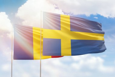 Sunny blue sky and flags of sweden and romania