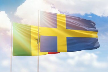 Sunny blue sky and flags of sweden and senegal