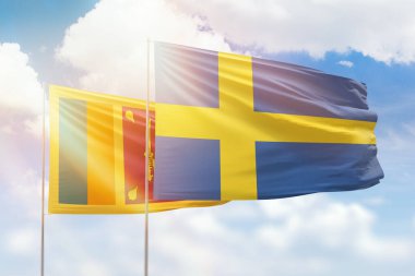 Sunny blue sky and flags of sweden and sri lanka