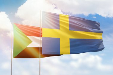 Sunny blue sky and flags of sweden and sudan