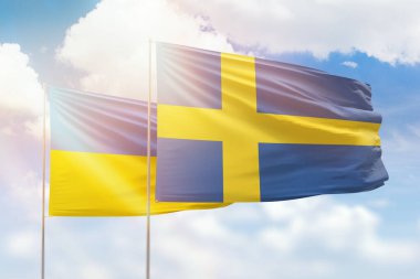 Sunny blue sky and flags of sweden and ukraine