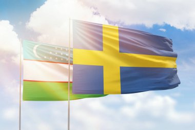 Sunny blue sky and flags of sweden and uzbekistan