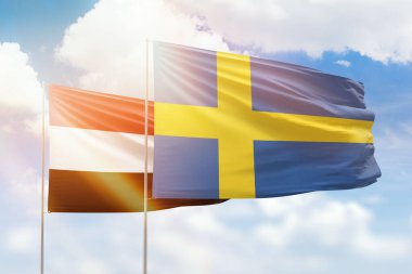 Sunny blue sky and flags of sweden and yemen