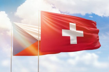 Sunny blue sky and flags of switzerland and czechia
