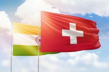 Sunny blue sky and flags of switzerland and india