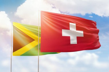 Sunny blue sky and flags of switzerland and jamaica