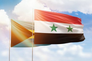 Sunny blue sky and flags of syria and bahamas