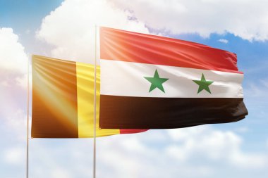 Sunny blue sky and flags of syria and belgium