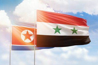 Sunny blue sky and flags of syria and north korea