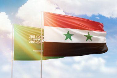 Sunny blue sky and flags of syria and saudi arabia