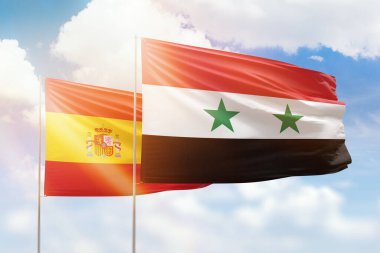 Sunny blue sky and flags of syria and spain