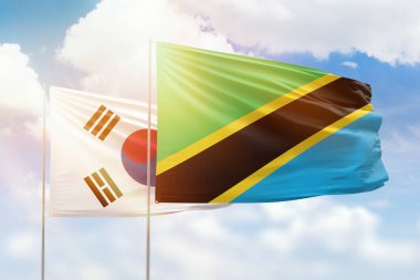 Sunny blue sky and flags of tanzania and south korea