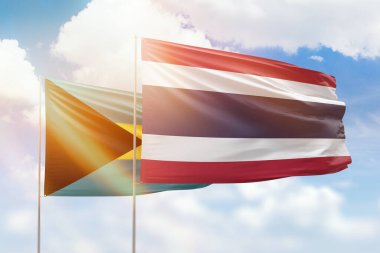 Sunny blue sky and flags of thailand and bahamas