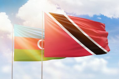 Sunny blue sky and flags of trinidad and tobago and azerbaijan