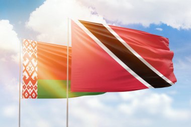 Sunny blue sky and flags of trinidad and tobago and belarus