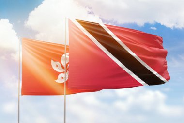 Sunny blue sky and flags of trinidad and tobago and hong kong