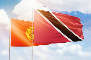 Sunny blue sky and flags of trinidad and tobago and kyrgyzstan