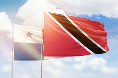 Sunny blue sky and flags of trinidad and tobago and panama