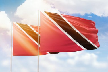 Sunny blue sky and flags of trinidad and tobago and trinidad and tobago