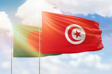 Sunny blue sky and flags of tunisia and bangladesh