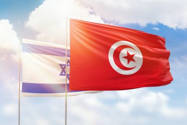 Sunny blue sky and flags of tunisia and israel