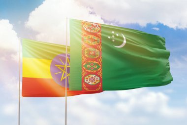Sunny blue sky and flags of turkmenistan and ethiopia