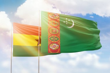 Sunny blue sky and flags of turkmenistan and ghana