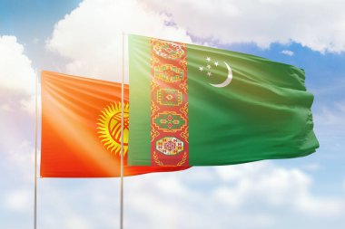 Sunny blue sky and flags of turkmenistan and kyrgyzstan