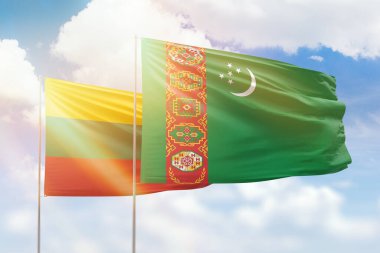 Sunny blue sky and flags of turkmenistan and lithuania