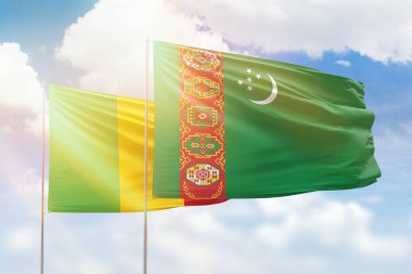Sunny blue sky and flags of turkmenistan and mali