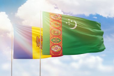 Sunny blue sky and flags of turkmenistan and moldova