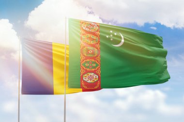 Sunny blue sky and flags of turkmenistan and romania