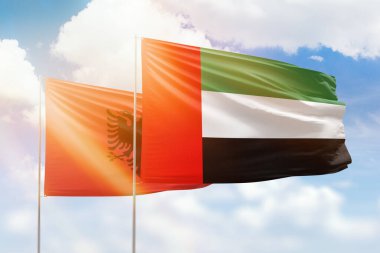 Sunny blue sky and flags of united arab emirates and albania