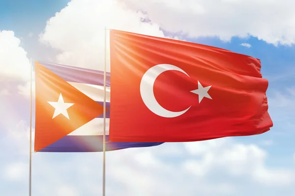 Sunny blue sky and flags of turkey and cuba