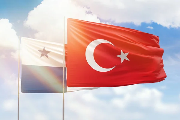 Sunny blue sky and flags of turkey and panama