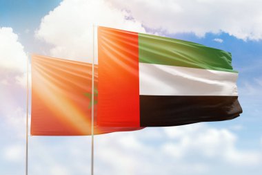Sunny blue sky and flags of united arab emirates and morocco