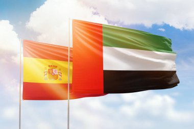 Sunny blue sky and flags of united arab emirates and spain
