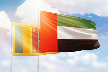 Sunny blue sky and flags of united arab emirates and sri lanka
