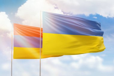 Sunny blue sky and flags of ukraine and armenia