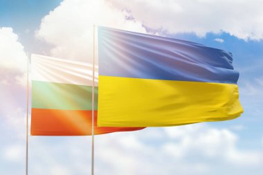 Sunny blue sky and flags of ukraine and bulgaria